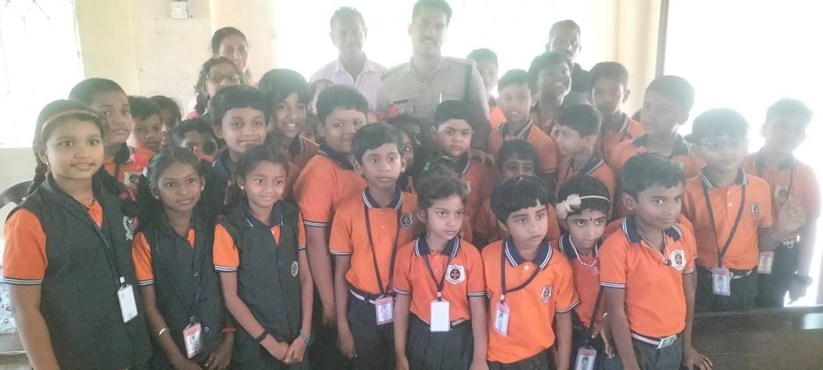 Pupils grouped round the visiting officer for a photograph at the end of the class.