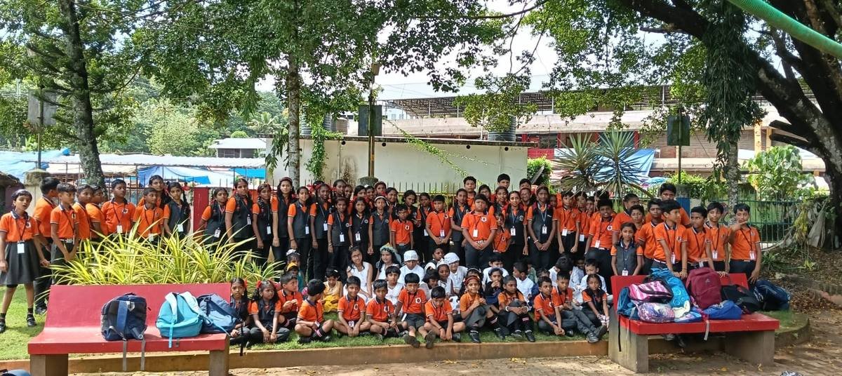 The whole school ranged under the trees at Kadakkal park, the youngest seated on the grass in front.