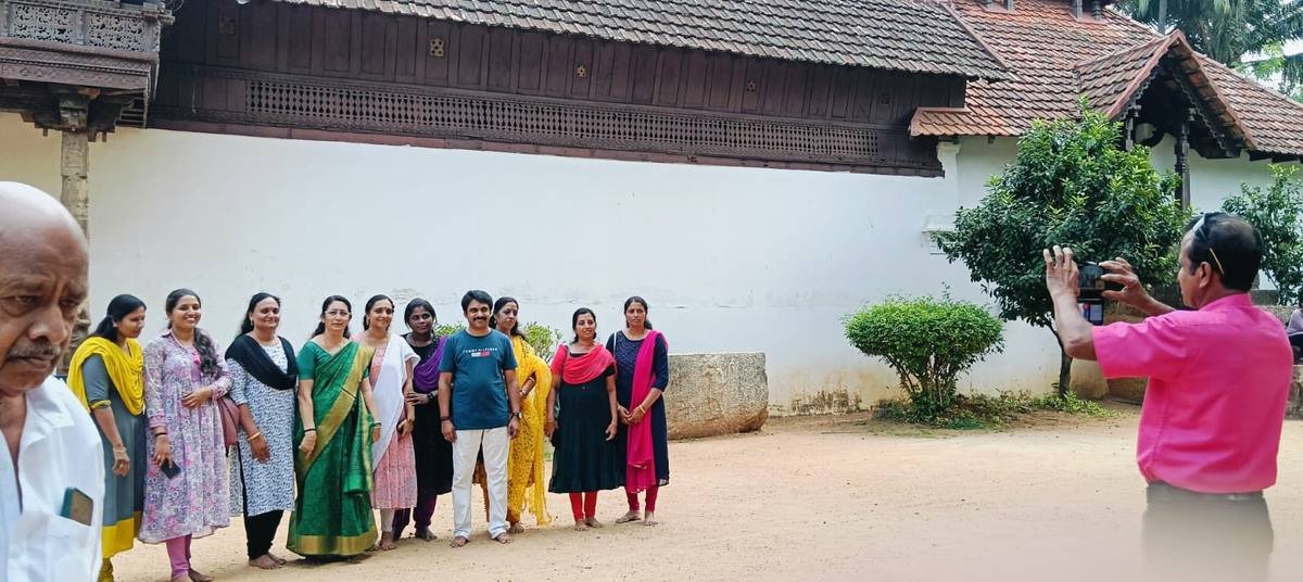 The teachers on the tour lining up for a group photograph against the palace wall.