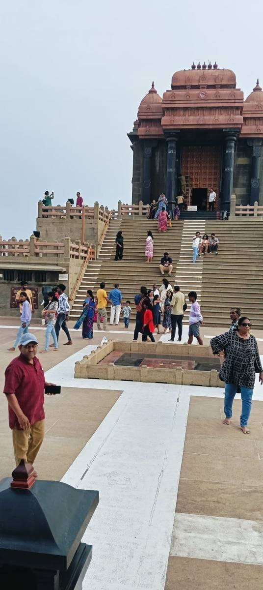 The memorial from the landing, visitors climbing the steps towards its doorway.