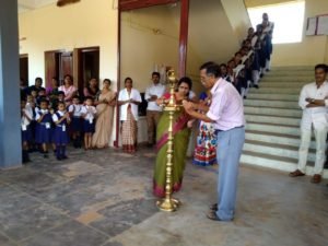 Lamp-lighting at a school gathering.